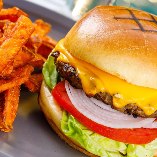 A juicy cheeseburger with lettuce, tomato, onion and melted cheddar, served with crispy seasoned fries.